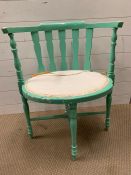 A painted tub style chair on turned legs and stretcher supports