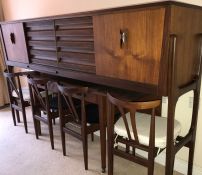 A Mid Century teak Danish style modular wall unit and dining table, the dining table has