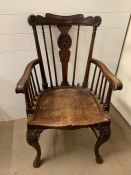 A late 19th century mahogany open armchair with saddle seat, slight carved cabriole legs