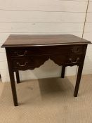 A mahogany low boy with three drawers (H74cm W88cm D48cm)