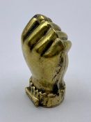A Brass Vesta case in the form of a fist
