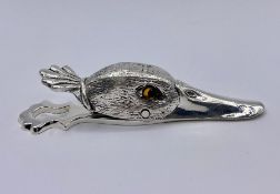 A Splatted paper clip in the form of a duck.