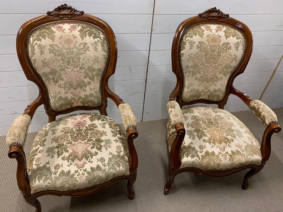 A pair of open armchairs on cabriole legs