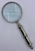 A large steel cased magnifying glass