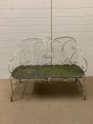 An ornate garden bench with scroll work to sides and back (H90cm W120cm D48cm)