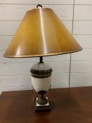 A table lamp in the form of an urn, raised up on square base with gold cracked shade