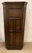 An oak half cupboard with linen fold front (H180cm W77cm D45cm)