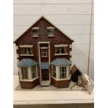 A vintage dolls house full of furniture, dolls, deck chairs etc AF (H70cm W60cm D32cm)