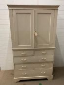 A vintage painted pine linen cupboard, doors opening up to reveal shelves and drawers under (