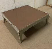A large square coffee table with guard rail and on cabriole legs