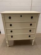 A white chest of drawers with fluted legs and four long drawers (H98cm W85cm D44cm)