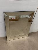 A wall mirror with mirrored frame sides (90cm x 70cm)