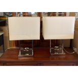 A pair of chrome table lamps with cream shades (H63cm)