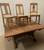 An oak dining table with a cross stretcher and lion paw shaped feet with six chairs. (H74cm W158cm