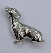 A silver dachshund brooch.