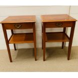 A pair of bedside cabinets with shelf under on square tapered legs