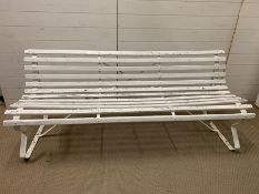 A garden wooden slatted bench on wrought iron base (H80cm W184cm D45cm)