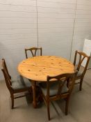 A pine dining table and four chairs by Ducal