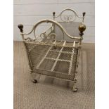 An early child's dolls cot with brass knobs to ends and castors (H40cm W56cm W32cm)