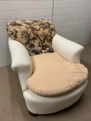 An easy armchair on turned bun feet and sprung back (H88cm W107cm D93cm)