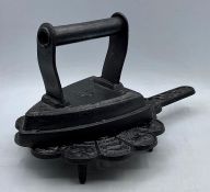 A cast iron flat iron and stand