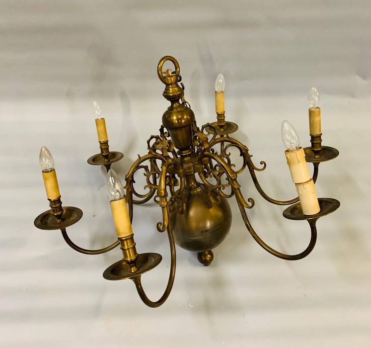A six arm brass chandelier with brass orb to bottom (H75cm W90cm)