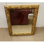 A carved gilt framed mirror (94cm x 74cm)