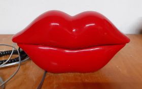 A vintage telephone red lips shaped, (22x11 cm).
