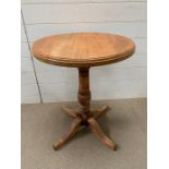 A circular side table on four spade feet (H68cm Dia55cm)