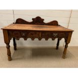 A carved low table with animal carved drawer handles and turned legs (H73cm W106cm D43cm0