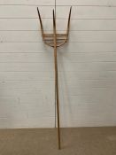 A vintage wooden hay fork