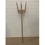 A vintage wooden hay fork