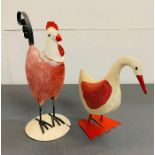 A metal decorative duck and hen