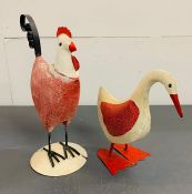 A metal decorative duck and hen