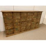 A large apothecary style chest of drawers (H106cm W198cm D41cm)