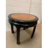 An ebonised style circular side table with inlay walnut style top (57cm H x 63 cm D)
