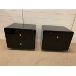 A pair of black lacquer bedsides (H47cm W56cm D42cm)