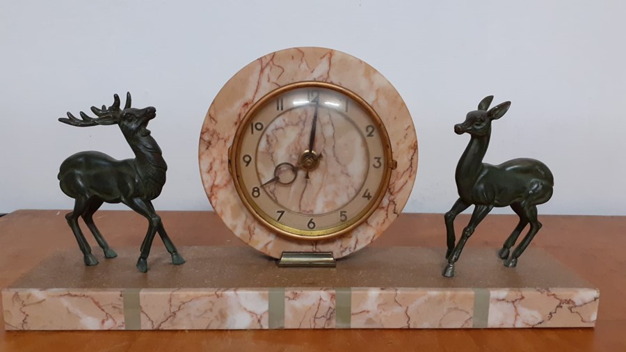 An Art Deco mantel clock, mounted with two deer's, the dial with Arabic numerals, (restauration), (