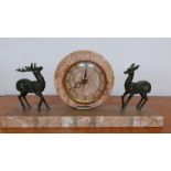 An Art Deco mantel clock, mounted with two deer's, the dial with Arabic numerals, (restauration), (