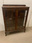 A mahogany glazed bookcase on cabriole legs with two glass shelves