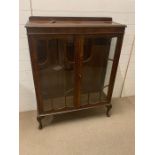 A mahogany glazed bookcase on cabriole legs with two glass shelves