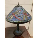 A Tiffany style table lamp with dragon fly design to shade and base