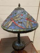 A Tiffany style table lamp with dragon fly design to shade and base