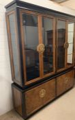 A reproduction lacquered effect Oriental glazed bookcase or display case with brass plate handles