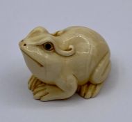 A carved and signed Frog Netsuke