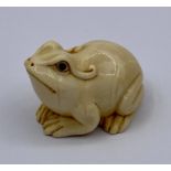 A carved and signed Frog Netsuke