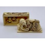 A carved and decorated erotic Japanese netsuke