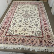 A large pink and cream ground rug W218cm x L336cm