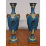 A pair of Neoclassical style baluster shaped urns with rams heads handles, marked with the company