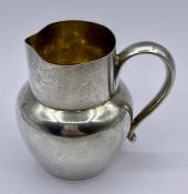 A small hallmarked silver jug, hallmarked for London 1889.(Total Weight 65g)